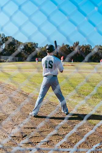 person baseball player near fence apparel