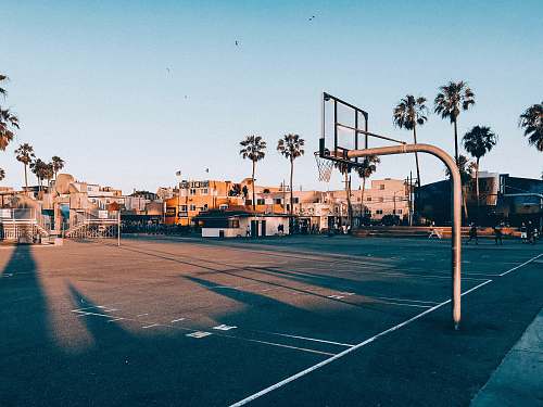 person basketball court during golden hour people