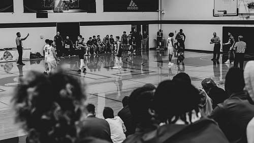 person basketball game inside court black-and-white