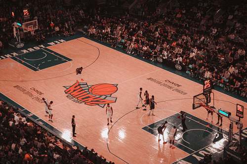 person basketball players playing on New York Knicks court people