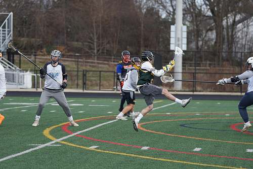 person black and whit elacrosse stick field