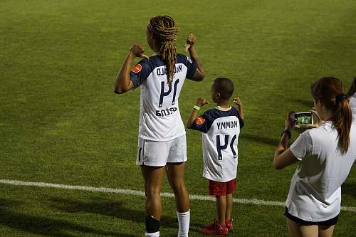 person boy and girl soccer players standing on soccer field people