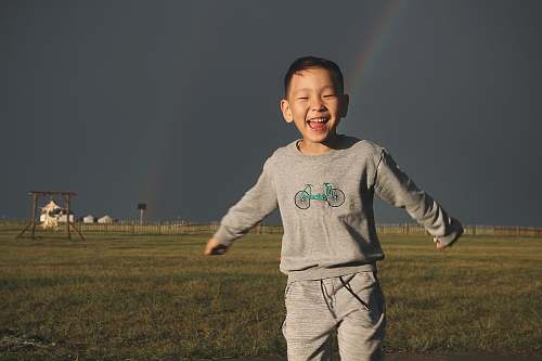 person boy on grass field boy