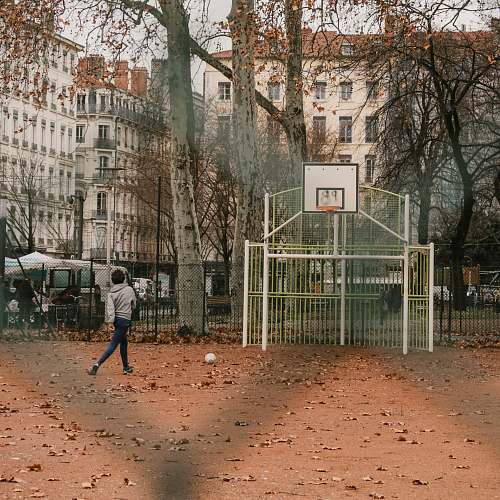 person boy standing near basketball hoop people