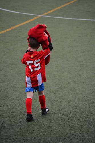 person boy wearing red and white 27 soccer jersey shirt people