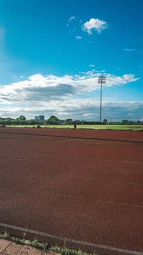 person brown and black running tracks sport