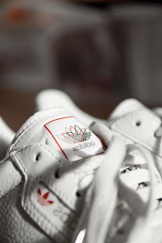clothing closeup photo and seletive focus photography of Adidas sneakers apparel