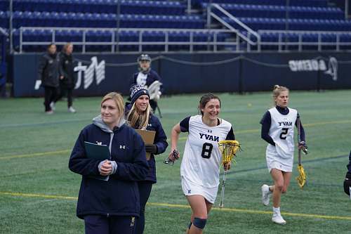 person female lacrosse team on field people