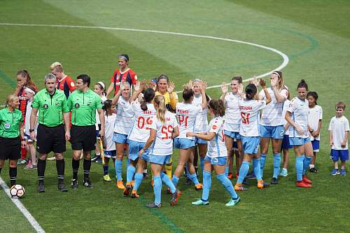 person female soccer team standing on field with officials and children people