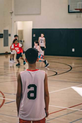 person focus photo of a man wearing white and red 6 jersey shirt people