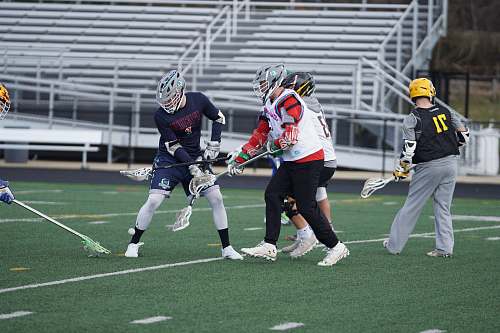 apparel four lacrosse player holding sticks person