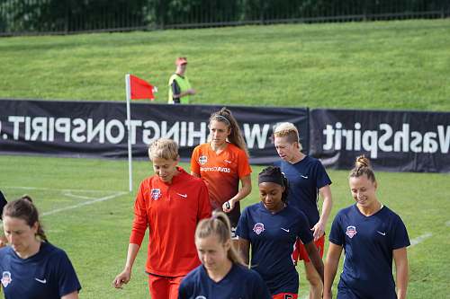 person girl walking on soccer field people
