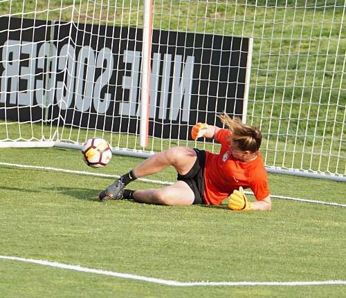 person goal keeper lying on grass people