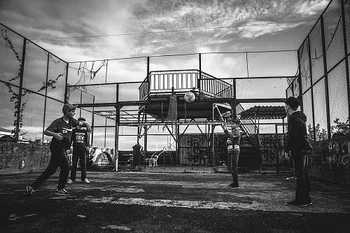 person grayscale photo of group of boys playing baseball black-and-white