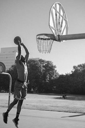 person grayscale photography of man playing basketball black-and-white