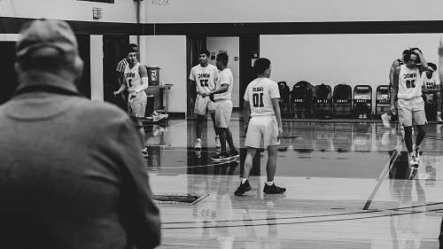 person grayscale photography of players inside court black-and-white