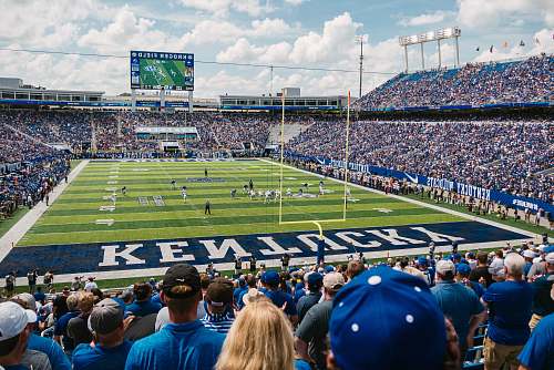 person green and blue Kentucky stadium field