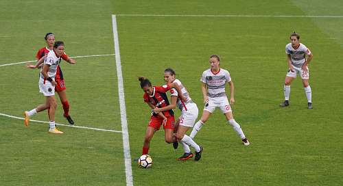 person group of females playing soccer people