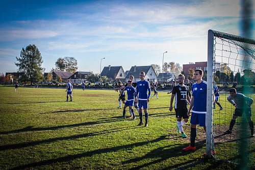person group of football player under blue sky people