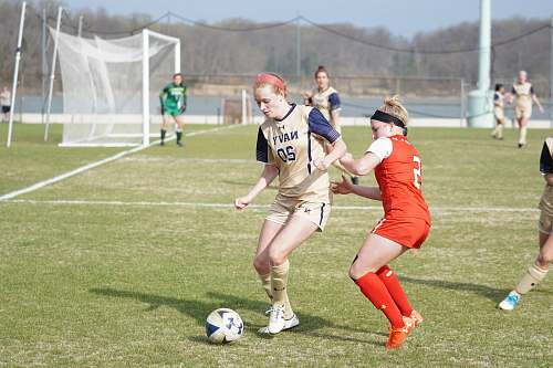 person group of girls playing soccer during daytime people