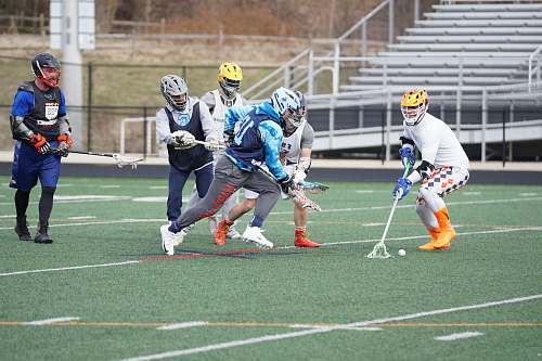 person group of men holding lacrosse sticks apparel