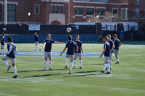 person group of men playing football on field people