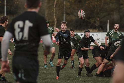 person group of men playing football sport