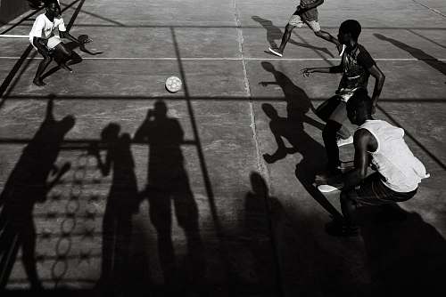 person group of men playing soccer black-and-white