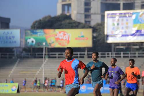 person group of men running during daytime people