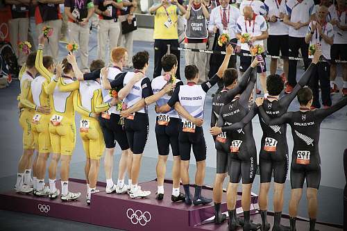 person group of men standing in podium holding flowers people