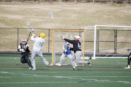 person group of men standing near goal net apparel