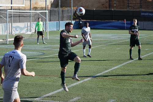 person group of people playing soccer during daytime people
