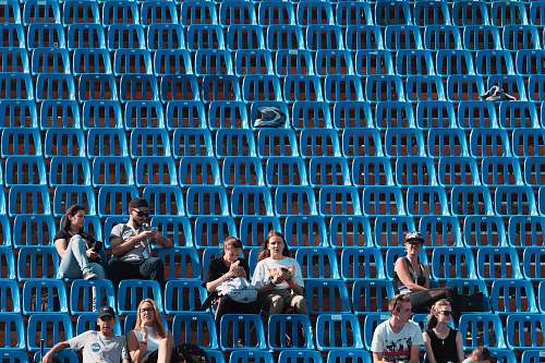 person group of people sitting on blue gang chair audience