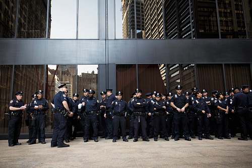 police group of police standing near grey building military