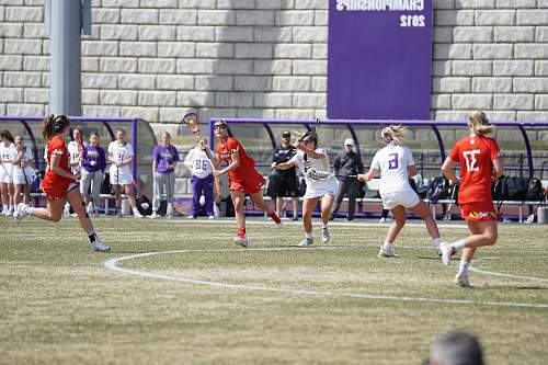 person group of woman playing lacrosse on field people