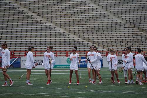 person group of women playing lacrosse during daytime people
