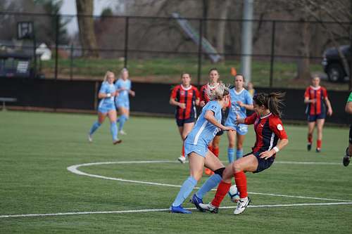person group of women playing soccer game on field people
