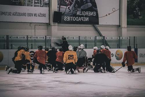 person hockey coach in front of hockey player people