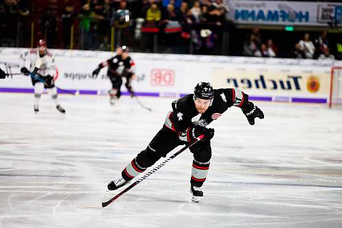 people ice hockey player sliding on ice rink team