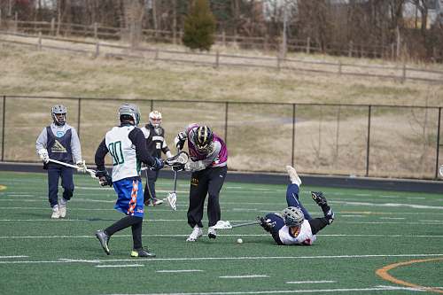 person lacrosse players on field at daytime apparel