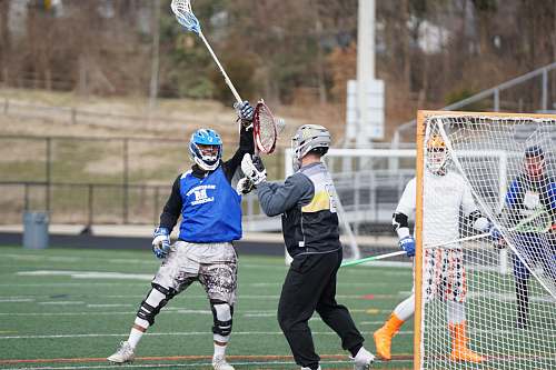 apparel lacrosse players playing on field at daytime clothing