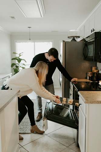 indoors man and woman by open range oven room