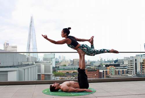 person man and woman doing yoga pose people
