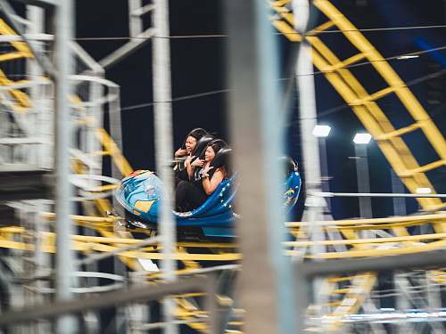 person man and woman on roller coaster people