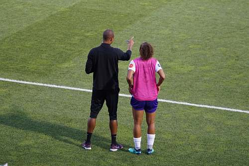 person man and woman standing on field people