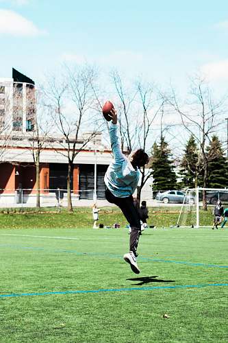 people man catching football at the field sport