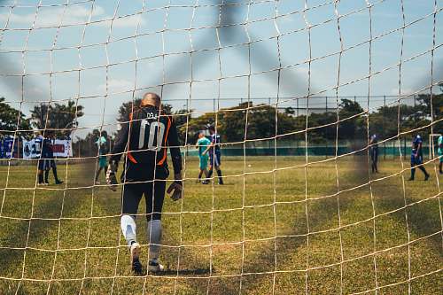 person man facing back on brown net people