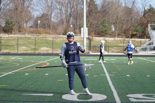 person man holding lacrosse stick apparel