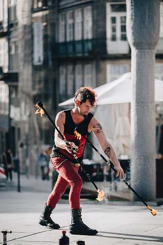 person man holding tiki torch standing near pillar hockey