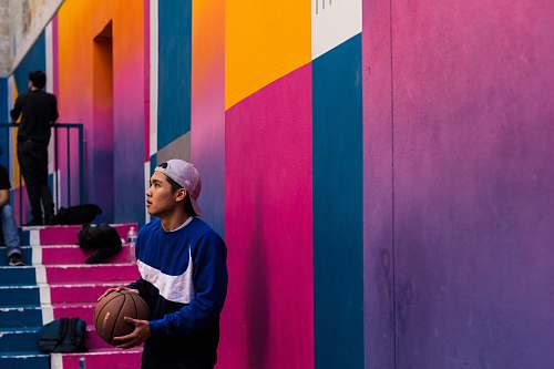 clothing man in blue and white Nike crew-neck sweater holding basketball person